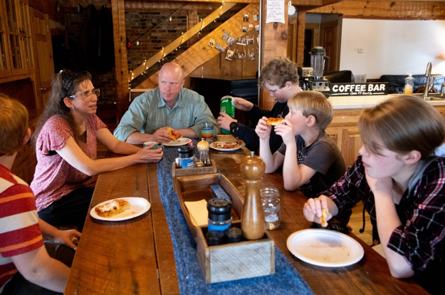 Gian and Larry Ryan eat lunch with their children at their home Friday, Feb. 7, 2020, in Pleasantville, Tenn. Since becoming disillusioned with traditional health insurance, the Ryans have relied on a Christian health sharing ministry to cover themselves and their nine children.